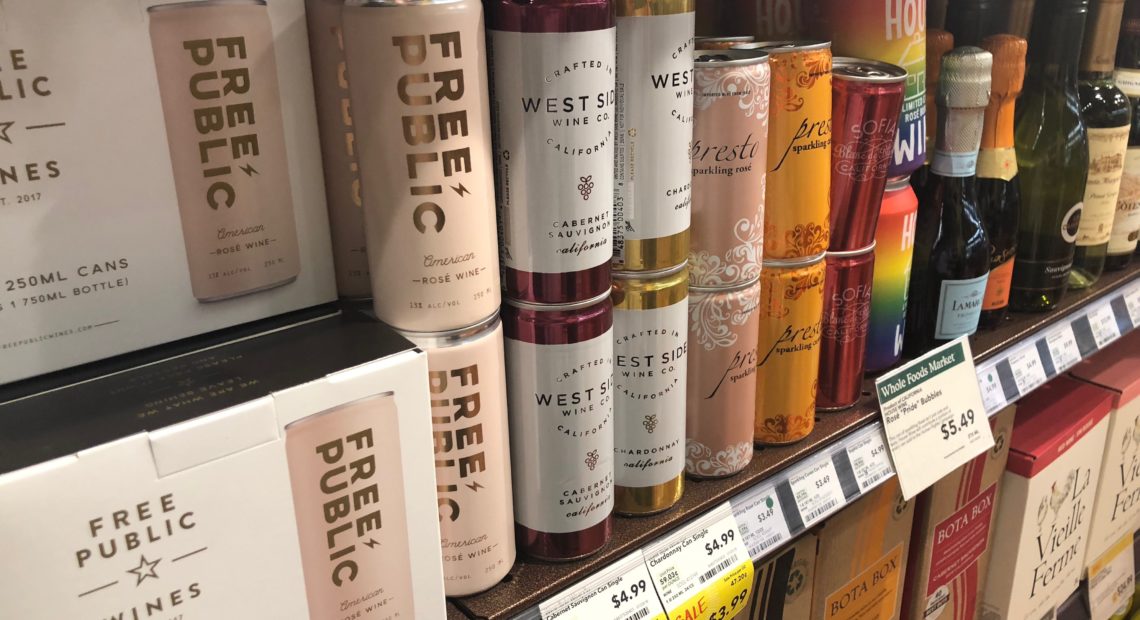 Stores like this busy Whole Foods in Portland, Ore., have started shuffling bottles around on shelves and in coolers to make room for wine in cans. CREDIT: ANNA KING/N3