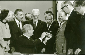 President Johnson hands the pen he used to sign the North Cascades National Park Act to sponsor Sen. Henry 