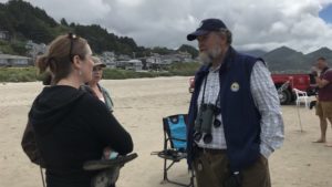 Art Broszeit, a volunteer for the Department of Interior, enjoys meeting beachgoers and talking about birds and ocean science. CREDIT: Kirk Siegler/NPR
