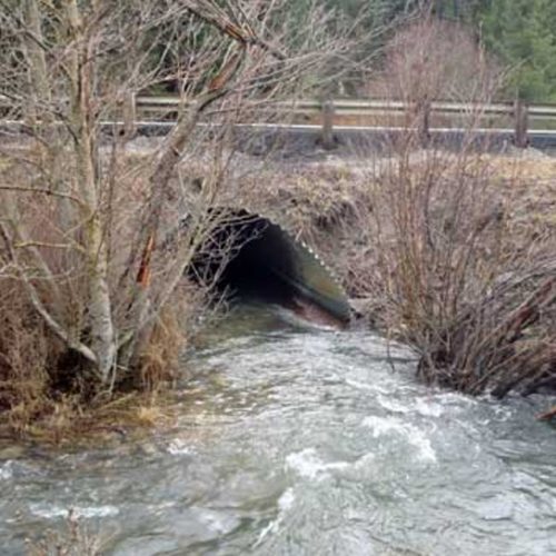 This is a culvert, or narrow passage for water to pass, in this case, under a highway. This culvert on the south side of the summit is a barrier to salmon and trout.