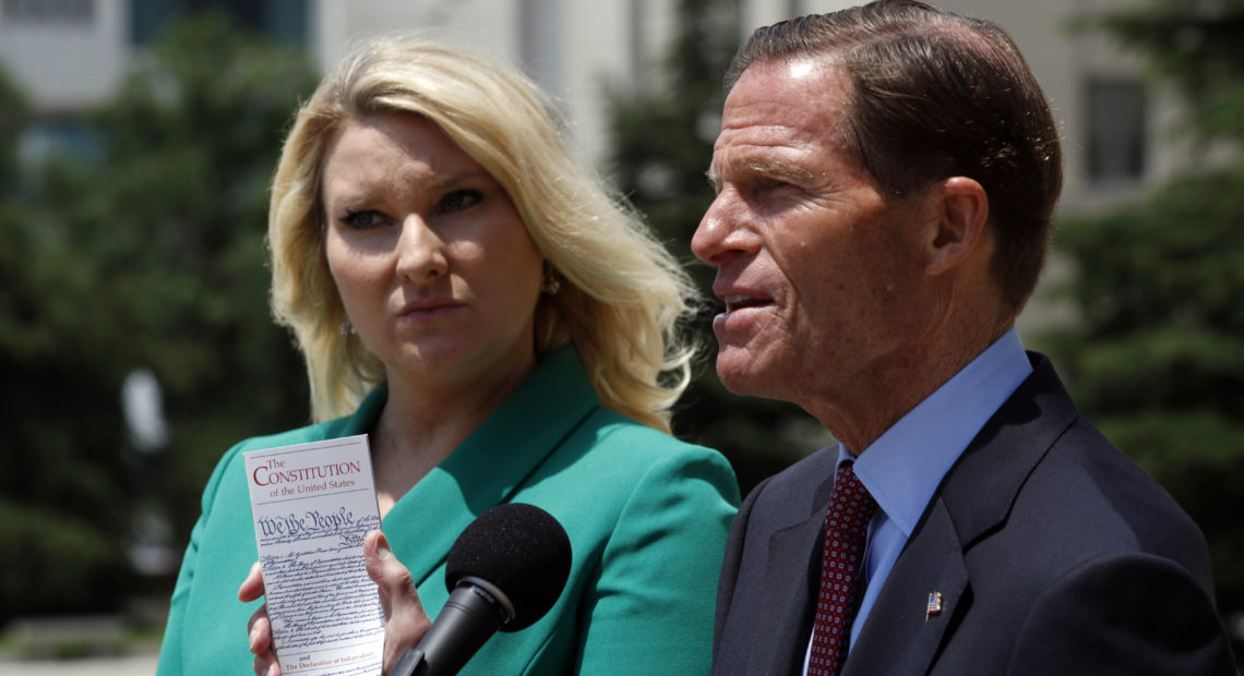 Sen. Richard Blumenthal, D-Conn. (right) and Elizabeth Wydra, congressional Democrats' attorney in a case accusing President Trump of violating the Constitution's Foreign Emoluments Clause, speak to reporters in June.