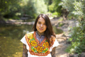 Arleene Correa Valencia stands by the creek on the Silverado Trail in Napa Valley. CREDIT: RACHAEL BONGIORNO/NPR