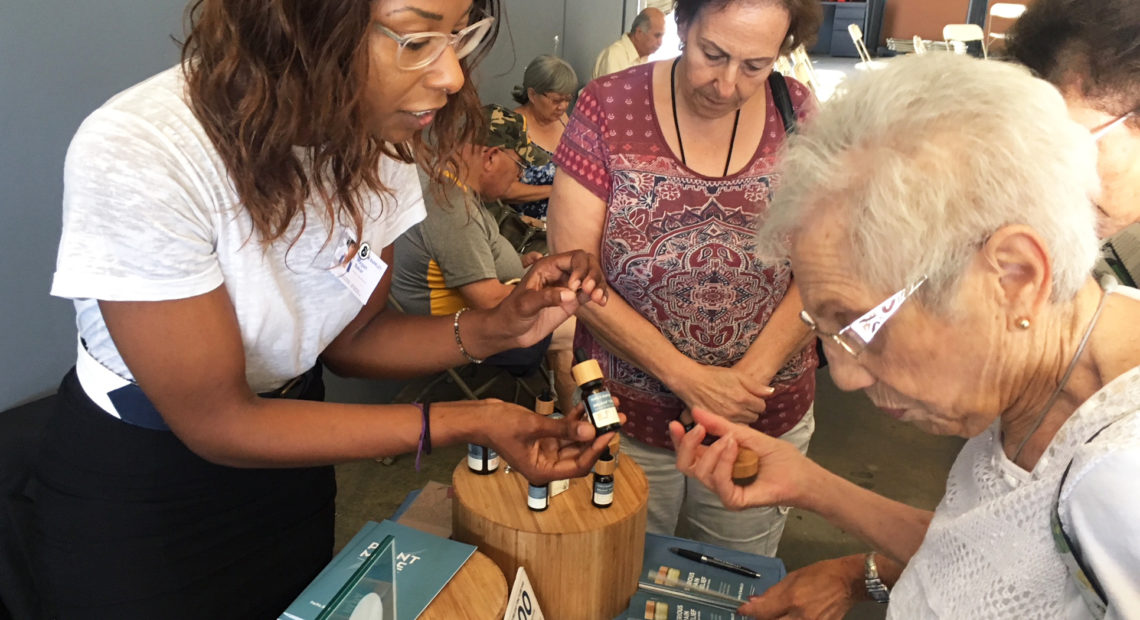 Megan Baker (left) of Papa & Barkley Co., a Cannabis company based in Eureka, Calif., shows Shirley Avedon of Laguna Woods different products intended to help with pain relief. CREDIT: STEPHANIE O'NEILL/NPR