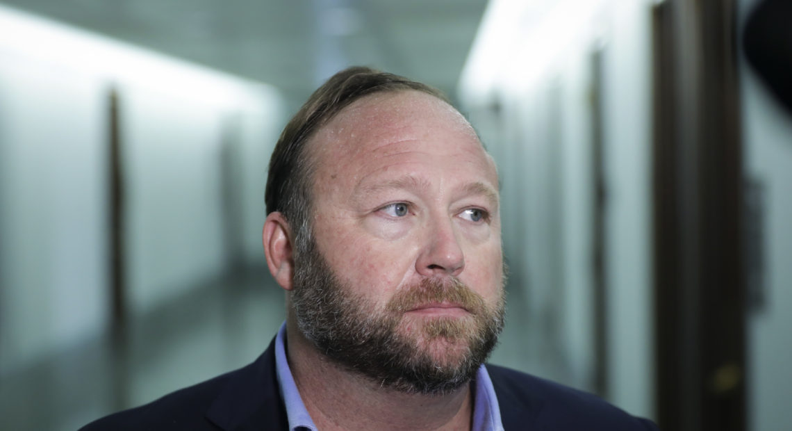 Alex Jones of InfoWars talks to reporters outside a Senate Intelligence Committee hearing on Wednesday. Twitter has permanently suspended the conspiracy theorist, citing violations of its policy on abusive behavior. CREDIT: Alex Jones of InfoWars talks to reporters outside a Senate Intelligence Committee hearing on Wednesday. Twitter has permanently suspended the conspiracy theorist, citing violations of its policy on abusive behavior. Drew Angerer/Getty Images