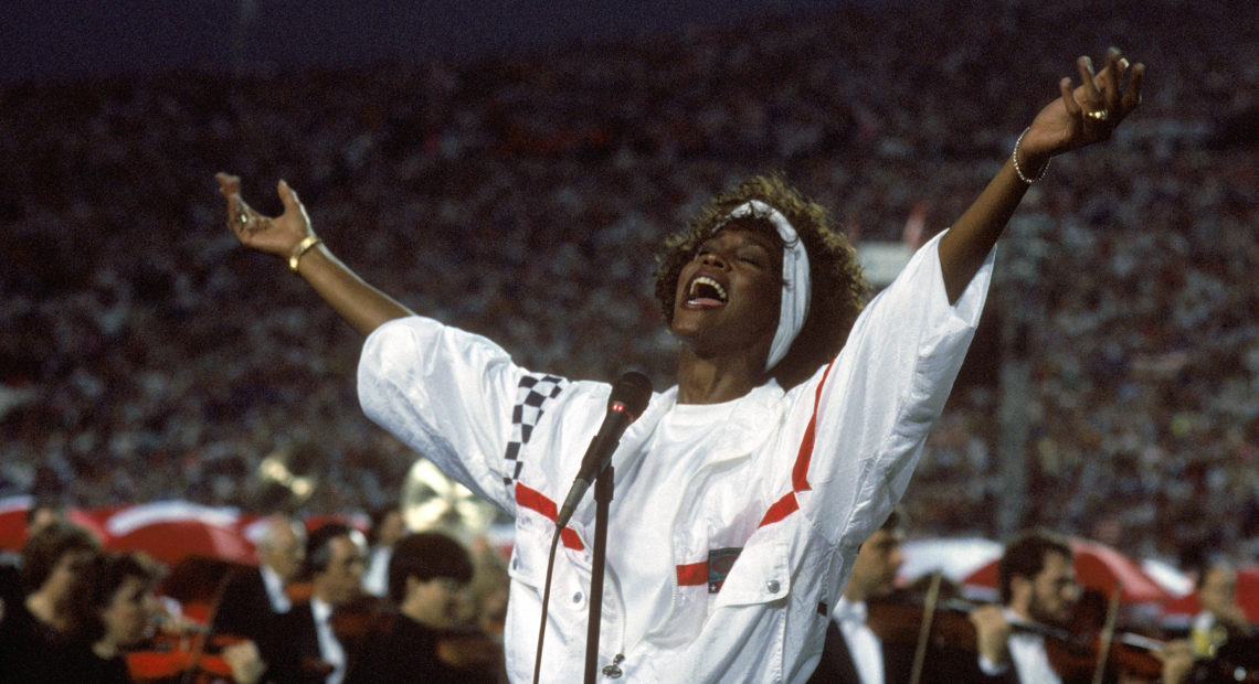 At Florida's Tampa Stadium in 1991, Whitney Houston delivered an iconic performance of "The Star Spangled Banner" to kick off Super Bowl XXV. CREDIT: GEORGE ROSE/GETTY IMAGES