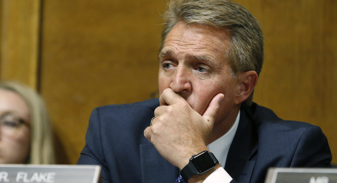 Sen. Jeff Flake, R-Ariz., listens as Christine Blasey Ford testifies before the Senate Judiciary Committee on Thursday.