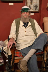 Gerald “Gerry” Matthews, 87, sits in a raised chair at the Museum of Un-Natural History in Walla Walla. Matthews opened the museum filled with his art in September 2001. CREDIT: T.J. Tranchell/Northwest Public Broadcasting
