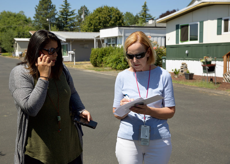 Mary Horman (left), a registered nurse for Clackamas County, and Liz Baca, a disease intervention specialist for the county, search for the right address in an Oregon neighborhood. Part of their job is to get information to people who may have a serious, treatable infection, yet not realize it. CREDIT: KRISTIAN FODEN-VENCIL