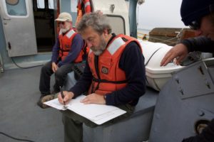 NOAA fisheries biologist, Curtis Roegner records scientific data on the health of crab populations. Low-oxygen levels have killed off large populations of crabs during hypoxia events in the past. CREDIT: KRISTIAN FODEN-VENCIL