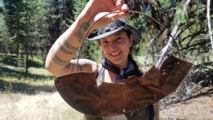 Southern Oregon University archaeologist Chelsea Rose with remnants of a five-part gold pan found during a dig this summer. CREDIT SOUTHERN OREGON UNIV. LABORATORY OF ANTHROPOLOGY
