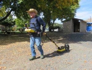 Lew Somers pulls a ground-penetrating radar instrument at Kam Wah Chung State Heritage Site CREDIT: TOM BANSE