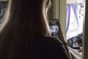 Zoe Reeves photographs the damage done to her bedroom by Hurricane Michael at Tyndall Air Force Base. CREDIT: Kelly Walker/U.S. Air Force