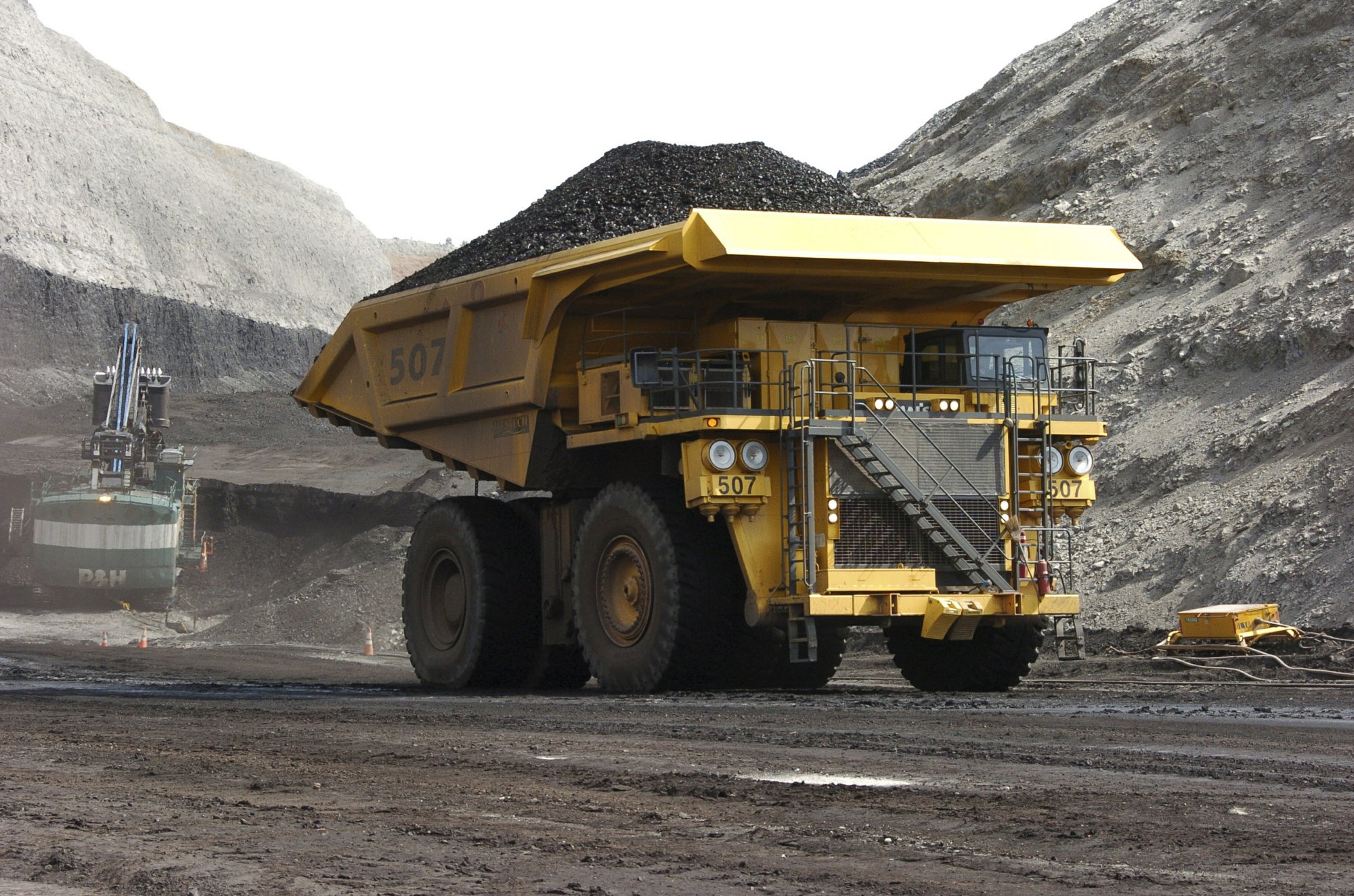 FILE - In this April 4, 2013, file photo, a mining dumper truck hauls coal at Cloud Peak Energy's Spring Creek strip mine near Decker, Mont. The Trump administration is considering using West Coast military bases or other federal properties as transit points for shipments of U.S. coal and natural gas to Asia. CREDIT: MATTHEW BROWN