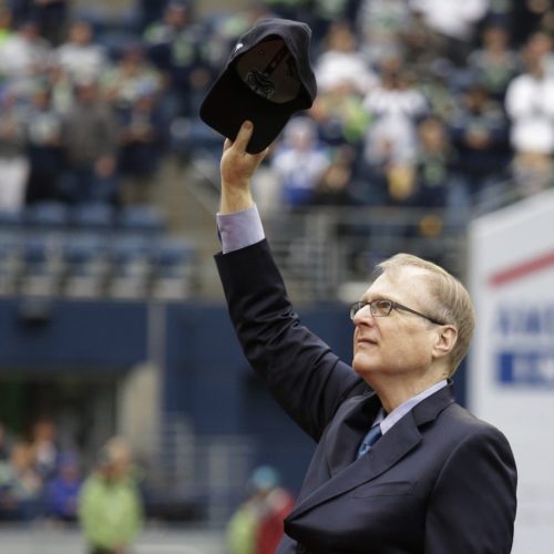 Seattle Seahawks owner Paul Allen tips his cap to fans as he is honored for his 20 years of team ownership before an NFL football game against the San Francisco 49ers, Sunday, Sept. 17, 2017, in Seattle. CREDIT: ELAINE THOMPSON