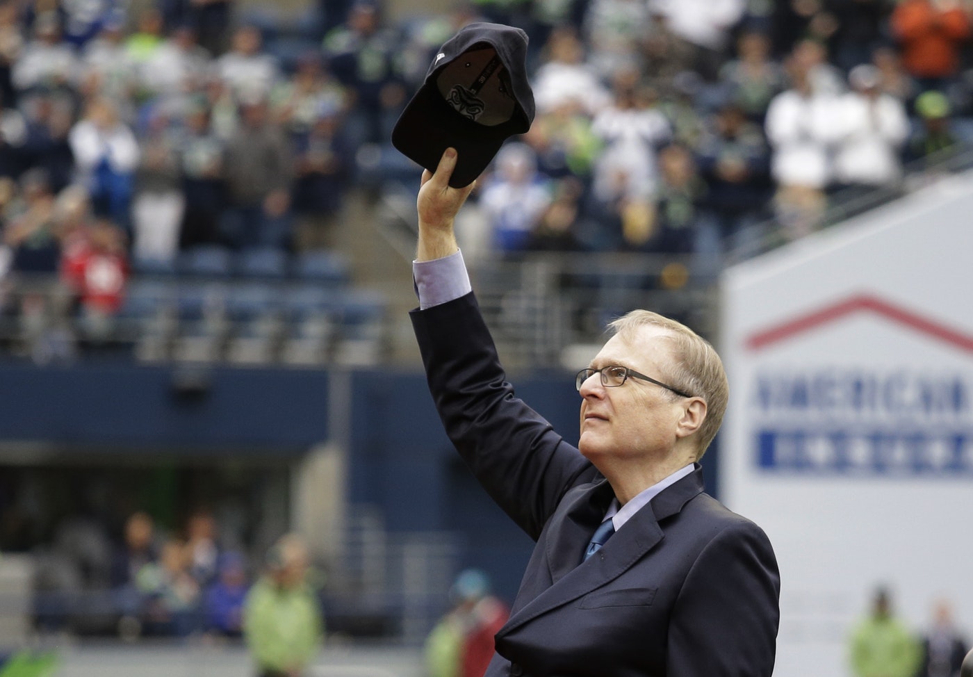Seattle Seahawks owner Paul Allen tips his cap to fans as he is honored for his 20 years of team ownership before an NFL football game against the San Francisco 49ers, Sunday, Sept. 17, 2017, in Seattle. CREDIT: ELAINE THOMPSON