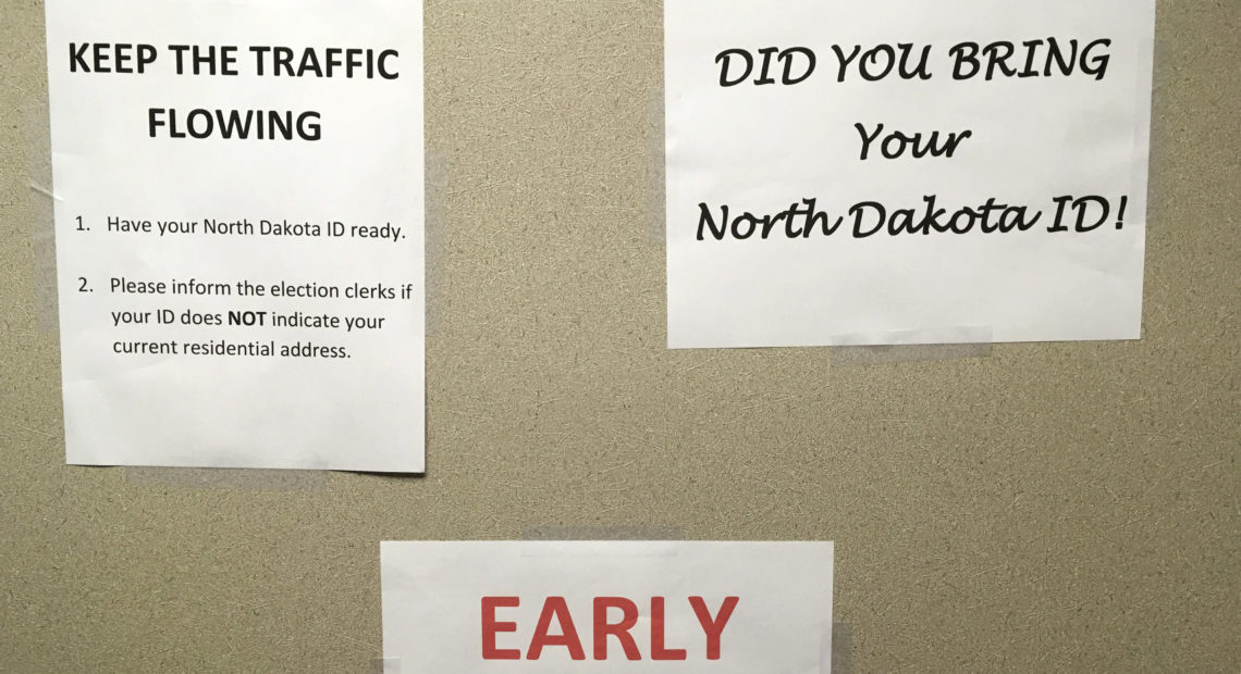 This June, instructions were posted at an early voting precinct in Bismarck, N.D. In that primary election, tribal IDs that did not show residential addresses were accepted as voter ID. But those same IDs will not be accepted in the general election. CREDIT: James MacPherson/AP