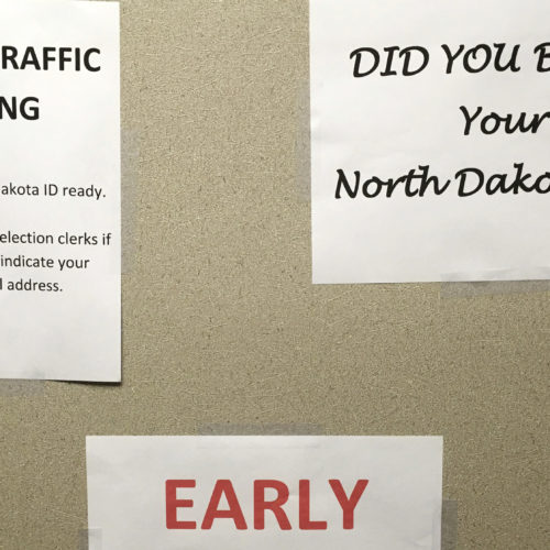 This June, instructions were posted at an early voting precinct in Bismarck, N.D. In that primary election, tribal IDs that did not show residential addresses were accepted as voter ID. But those same IDs will not be accepted in the general election. CREDIT: James MacPherson/AP
