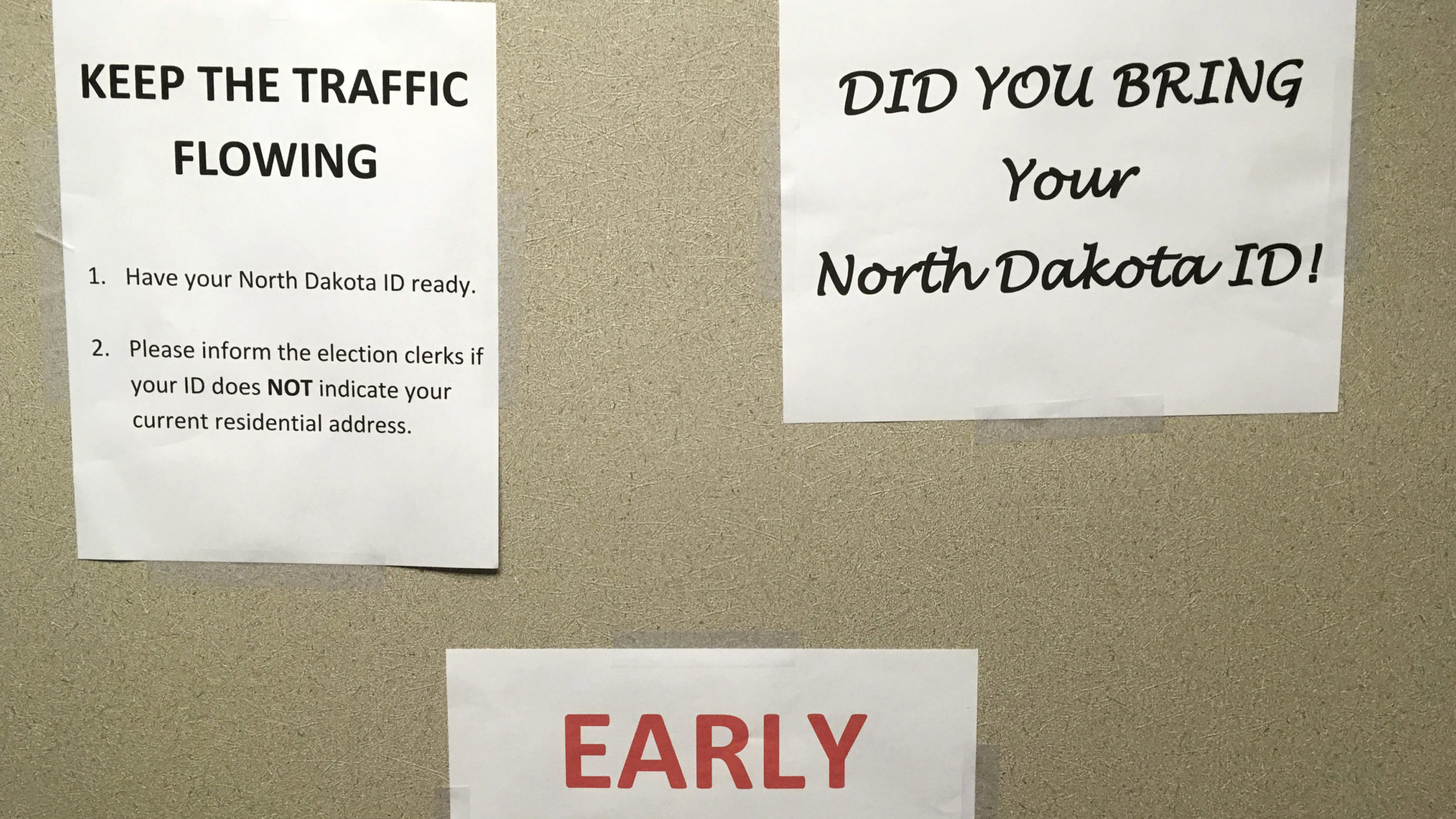 This June, instructions were posted at an early voting precinct in Bismarck, N.D. In that primary election, tribal IDs that did not show residential addresses were accepted as voter ID. But those same IDs will not be accepted in the general election. CREDIT: James MacPherson/AP