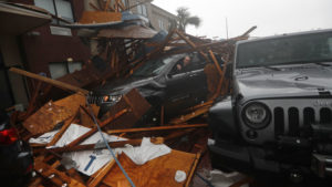 A storm chaser climbs into his vehicle as the eye of Hurricane Michael passes over Panama City Beach, Fla., hoping to retrieve his equipment after a hotel canopy collapsed in the parking area. The storm came ashore as a nearly Category 5 hurricane Wednesday.