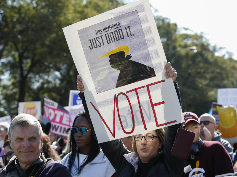 Women gather for a rally and march at Grant Park on Saturday in Chicago to urge voter turnout ahead of the midterm elections. CREDIT: KAMIL KRZACZYNSKI