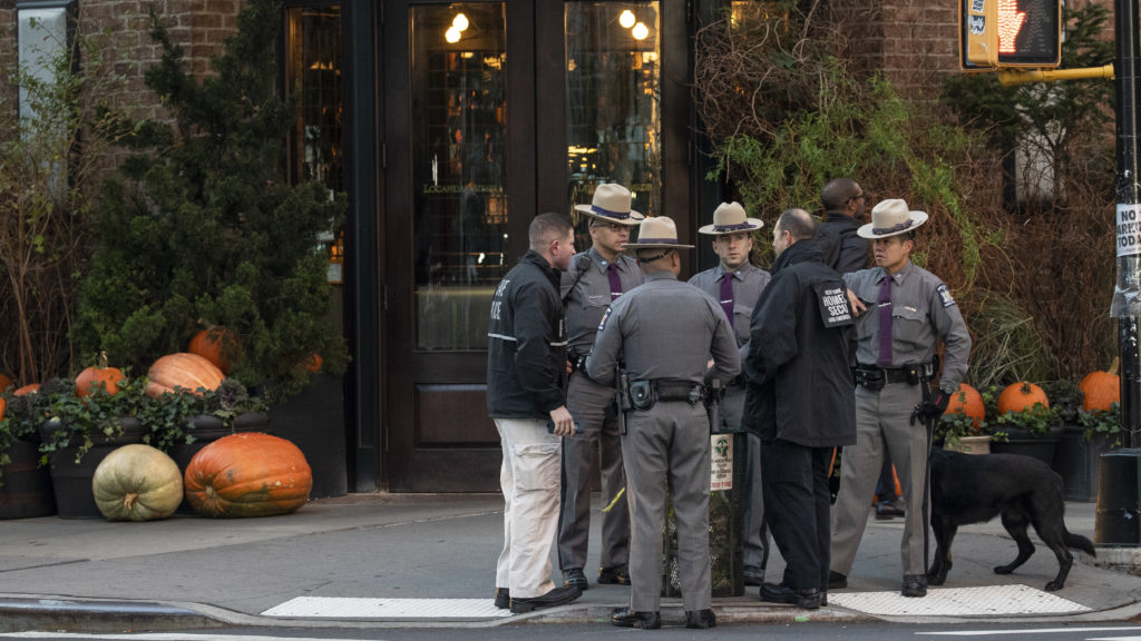 Law enforcement officials gather near Robert De Niro's Tribeca Grill restaurant in New York City after another suspicious package was found early Thursday.