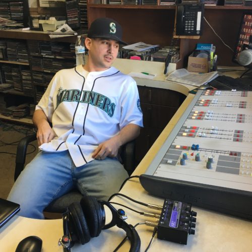 KYNR host Ryan Craig at the station in February 2018, in front of the audio board that was stolen in October. CREDIT: Esmy Jimenez/NWPB