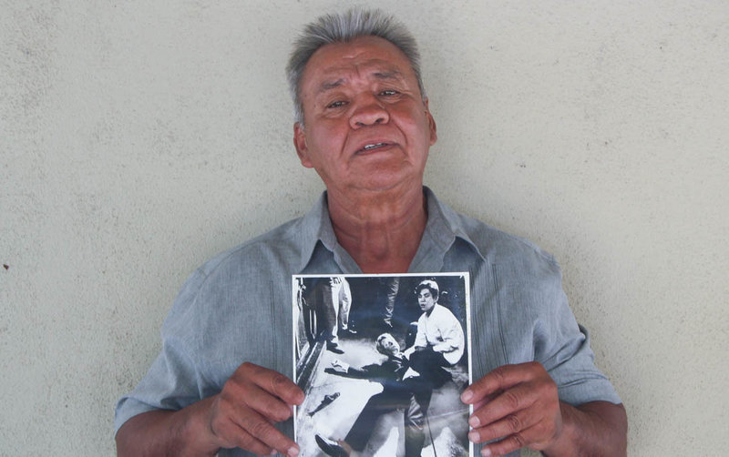Juan Romero earlier this year at his home in Modesto, Calif., holding a photo of himself and Sen. Robert F. Kennedy, taken by The Los Angeles Times' Boris Yaro on June 5, 1968. Romero died this week at age 68. CREDIT: Jud Esty-Kendall/StoryCorps