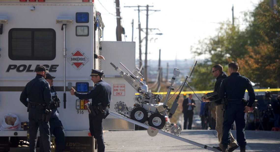 Law enforcement personnel operate a bomb disposal robot outside a post office which had been evacuated in Wilmington, Del., on Thursday.