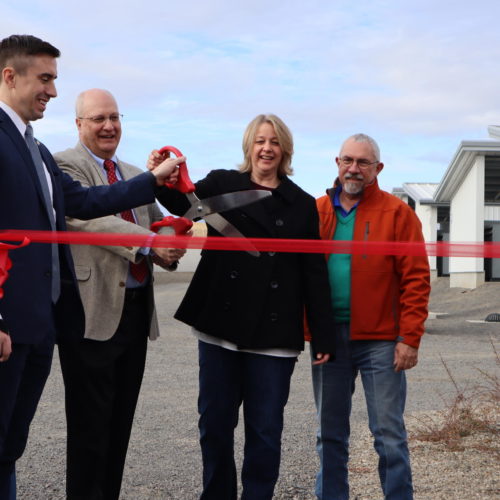 Dignitaries cut the ribbon at the grand opening of Bitmain's new East Wenatchee bitcoin mine -- in other words, a data center that earns cryptocurrency. CREDIT: TOM BANSE