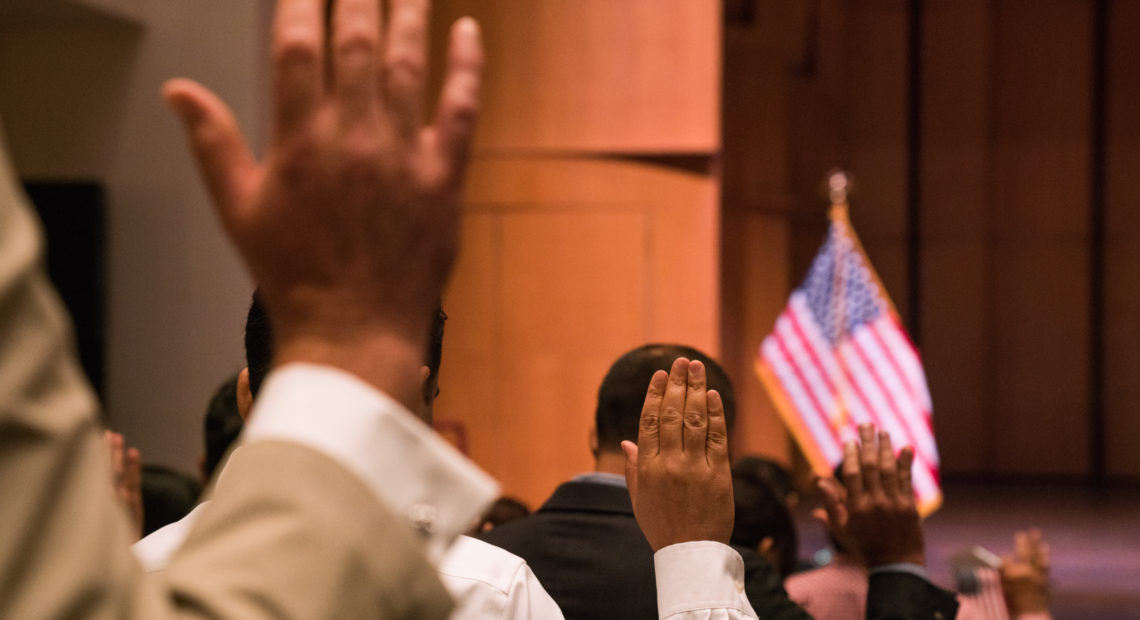 Newly sworn-in U.S. citizens gather for a naturalization ceremony at the Rachel M. Schlesinger Concert Hall and Arts Center in Alexandria, Va., in August. The Trump administration is planning to include a question about U.S. citizenship status on the 2020 census. Claire Harbage/NPR