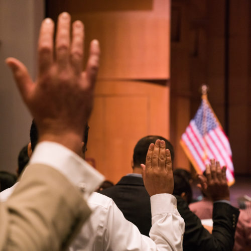 Newly sworn-in U.S. citizens gather for a naturalization ceremony at the Rachel M. Schlesinger Concert Hall and Arts Center in Alexandria, Va., in August. The Trump administration is planning to include a question about U.S. citizenship status on the 2020 census. Claire Harbage/NPR