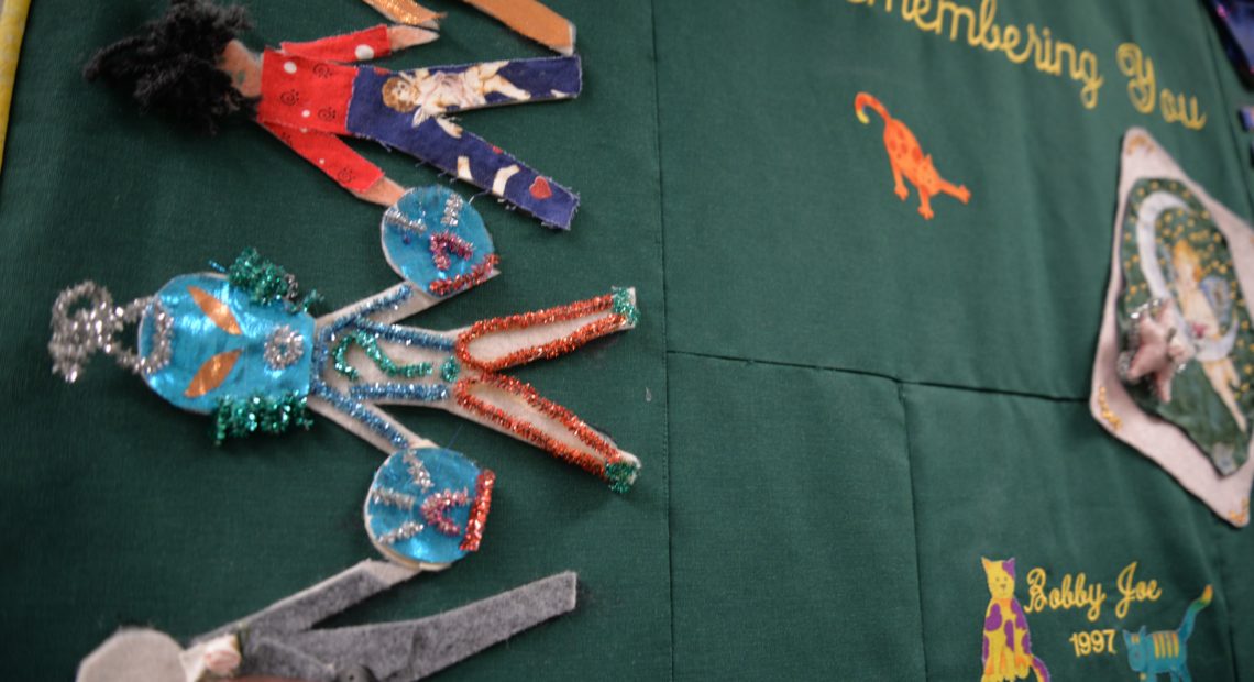 Inside New Hope Clinic, quilts like this one adorn the hallways. Often they’re made by the families of HIV and AIDS patients. This one was used as coffin cover for Bobby Joe, a patient who died in 1997. CREDIT: ESMY JIMENEZ/NWPB