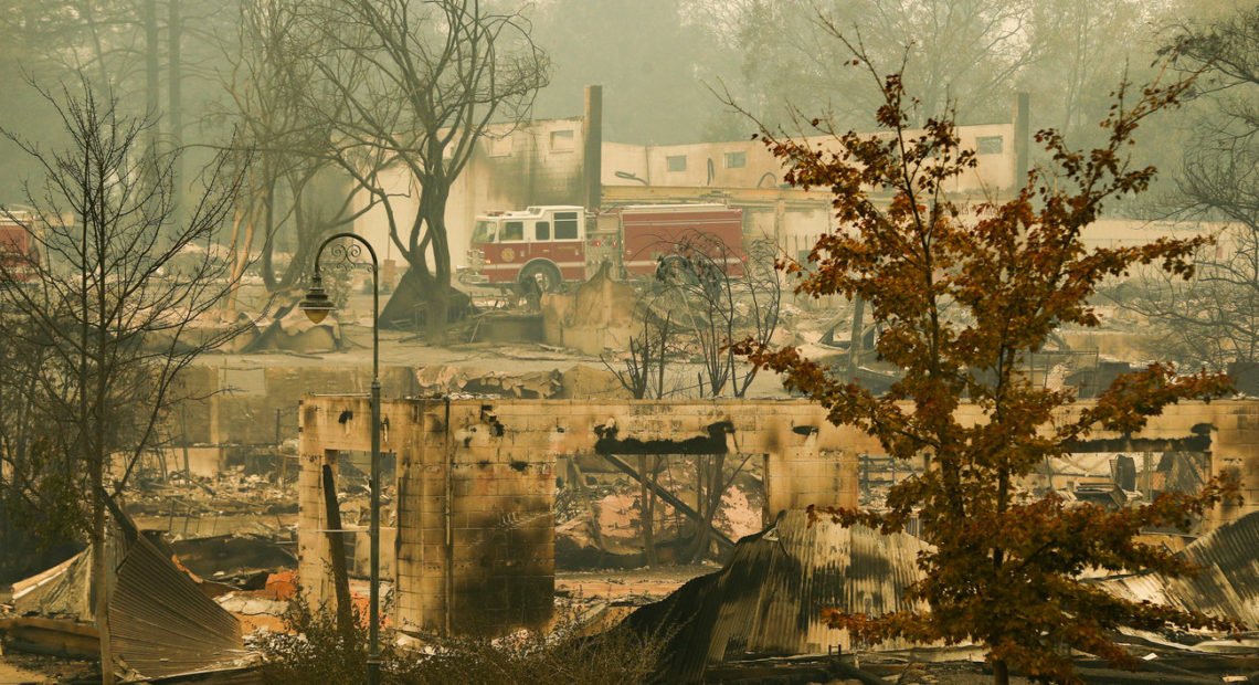 A fire truck drives through an area burned by the Camp Fire in Paradise on Tuesday, Nov. 15, 2018. CREDIT: John Locher/AP