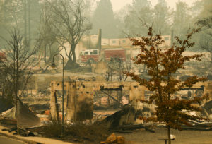 A fire truck drives through an area burned by the Camp Fire in Paradise on Tuesday, Nov. 15, 2018. CREDIT: John Locher/AP