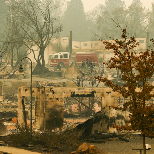 A fire truck drives through an area burned by the Camp Fire in Paradise on Tuesday, Nov. 15, 2018. CREDIT: John Locher/AP