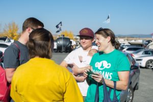 Garrett and Emily Strizich, right, co-founders of Reclaim Idaho, canvas the recent University of Idaho homecoming tailgate to drum up votes for Proposition 2. They even bring their three-month-old daughter, Simone, with them. CREDIT: JAMES DAWSON / BSPR