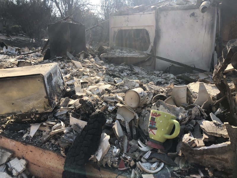 A holiday mug is seen among the wreckage of what was once someone's kitchen in Paradise, Calif. CREDIT: Elise Hu/NPR