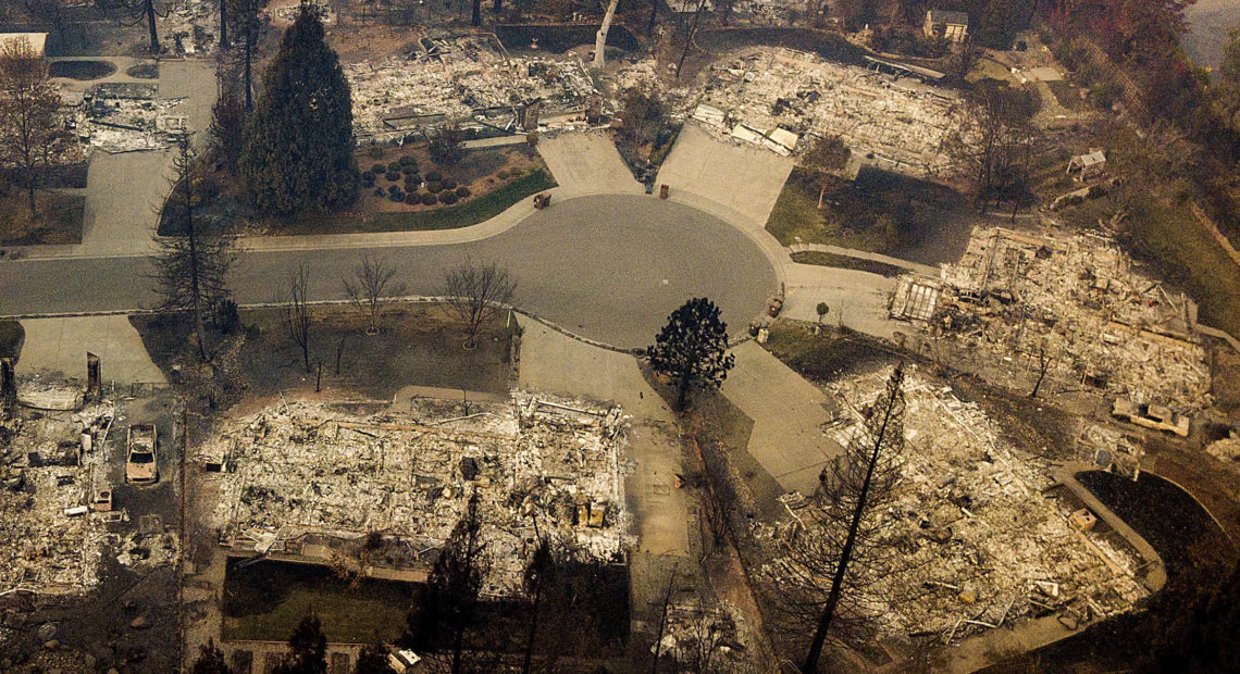 Residences leveled by the Camp Fire line a cul-de-sac in Paradise, Calif., earlier this month. A massive federal report says climate change is contributing to larger wildfires as well as other deadly extreme weather. CREDIT: Noah Berger/AP