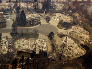 Residences leveled by the Camp Fire line a cul-de-sac in Paradise, Calif., earlier this month. A massive federal report says climate change is contributing to larger wildfires as well as other deadly extreme weather. CREDIT: Noah Berger/AP