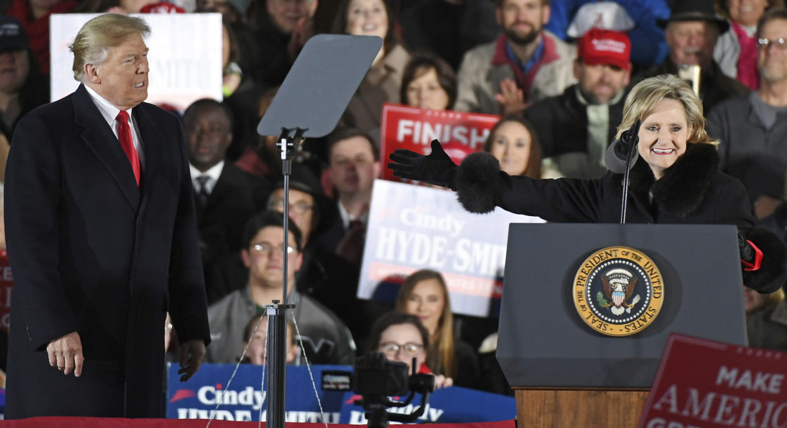 President Trump made two campaign appearances this week with Republican Sen. Cindy Hyde-Smith, who has stumbled over the state's racist past and faces a tight runoff election Tuesday. CREDIT: THOMAS GRANING/AP