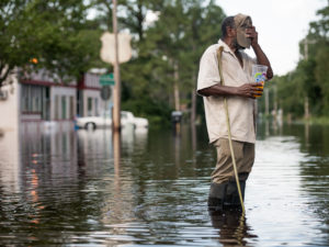 Larry Hickman stands in floodwaters caused by Hurricane Florence in September in Bucksport, S.C. CREDIT: Sean Rayford/Getty Images
