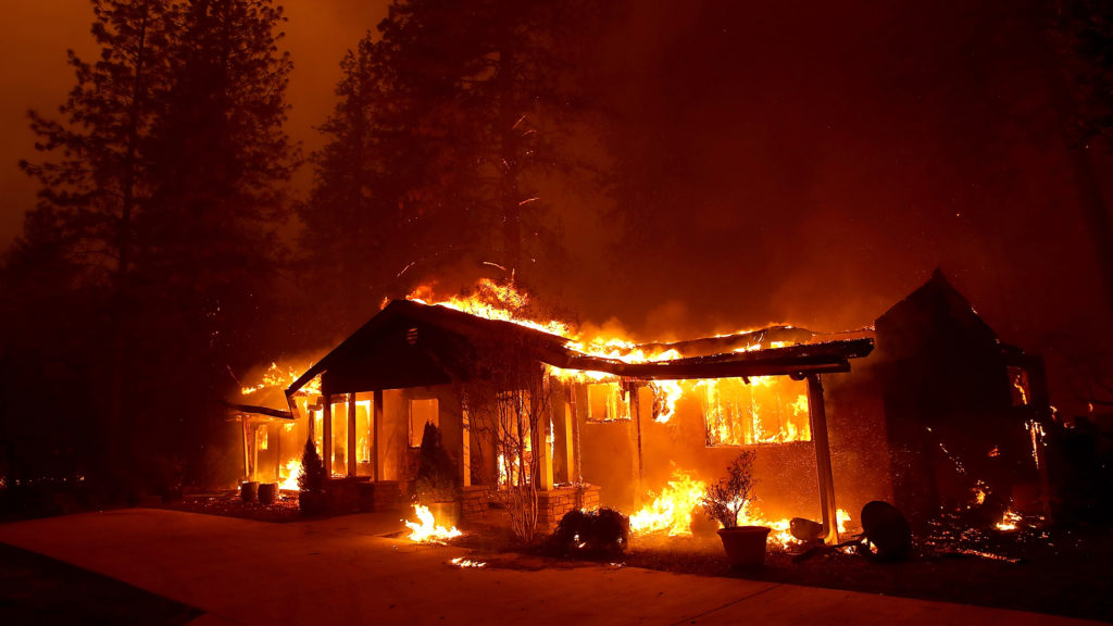 A home burns as the November 2018 Camp Fire moved through Paradise, Calif. Fueled by high winds and low humidity, the rapidly spreading fire killed 85 people and burned nearly 19,000 buildings in Butte County. CREDIT: Justin Sullivan/Getty Images