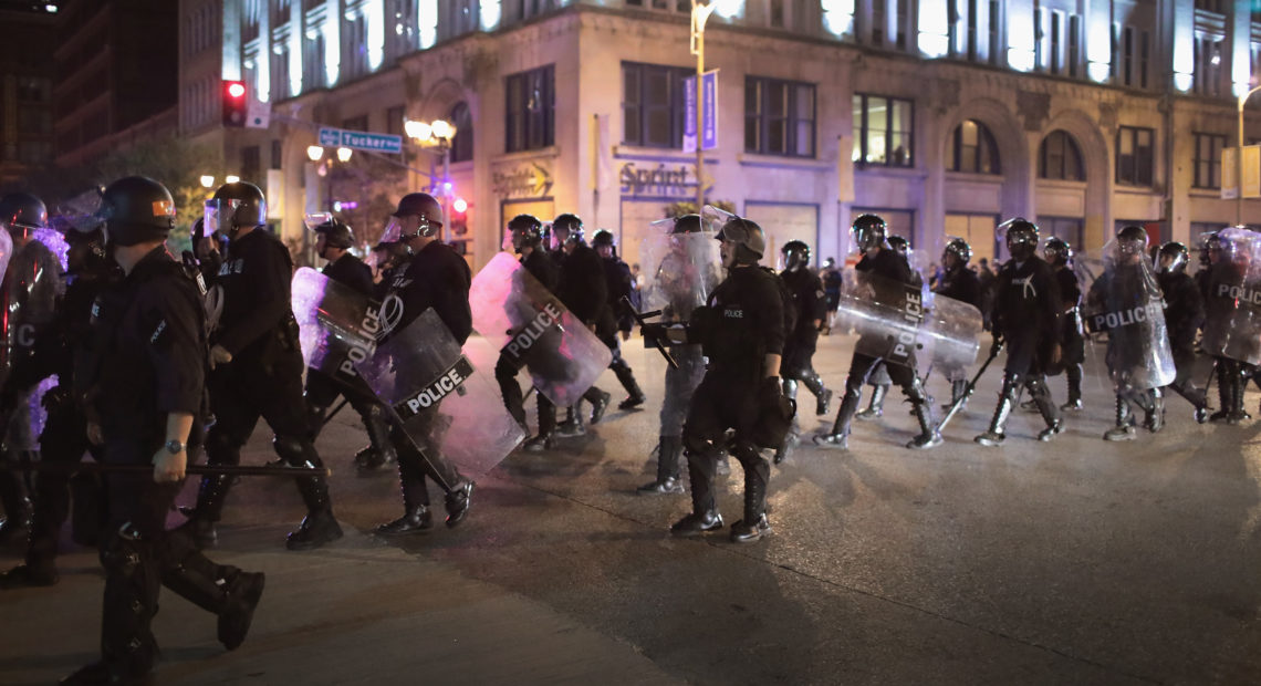 Police respond on Sept. 17, 2017, in St. Louis to demonstrators protesting the acquittal of former St. Louis police officer Jason Stockley, who had been charged with first-degree murder in a 2011 on-duty shooting. A federal grand jury on Thursday indicted three officers who responded to the protests in the beating of a fourth officer, who was working undercover that night. Scott Olson/Getty Images