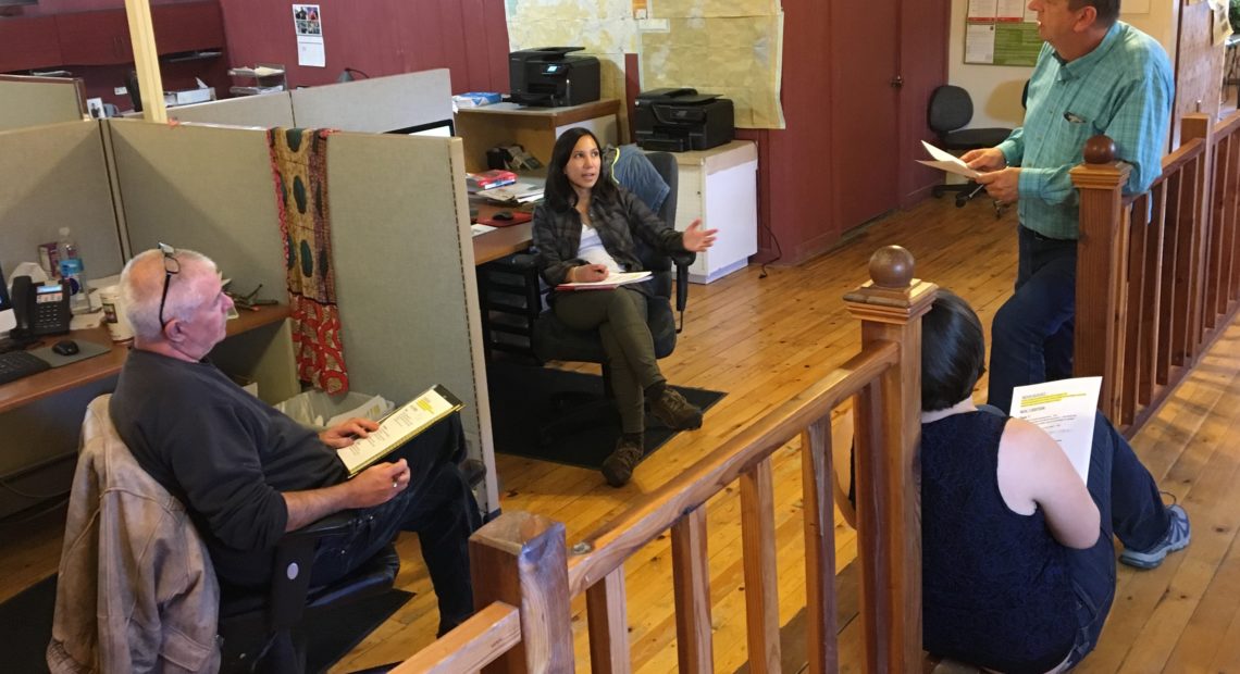 Malheur Enterprise reporters Pat Caldwell (from left) and Kristine de Leon; Les Zaitz, editor and publisher; and, sitting on the floor, reporter Jayme Fraser meet to talk about assignments. CREDIT: TOM GOLDMAN/NPR