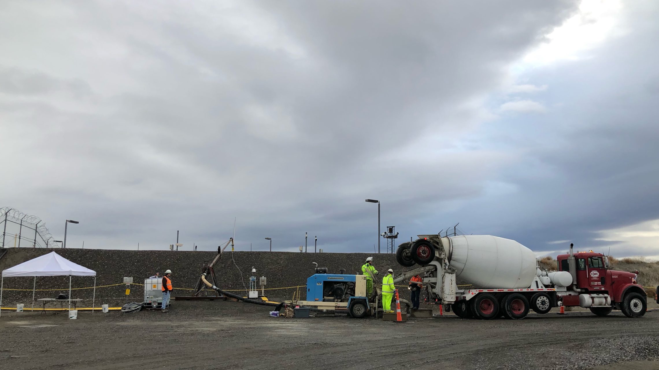 Hanford workers pump grout into a port on Tunnel 2. The tunnel is being sealed up so to lessen the risk of collapse that could endanger workers and the public. CREDIT: ANNA KING/N3