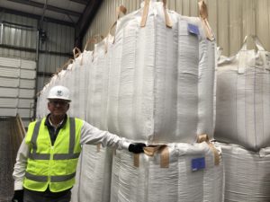 Phil Hinrichs stands near 2,500 pound export totes of garbanzo beans that his factory cleans and fills. These large containers will be loaded onto trucks and shipped around the world. The problem for Hinrichs is, not much of anything is shipping right now with trade tariffs in place against American commodities.