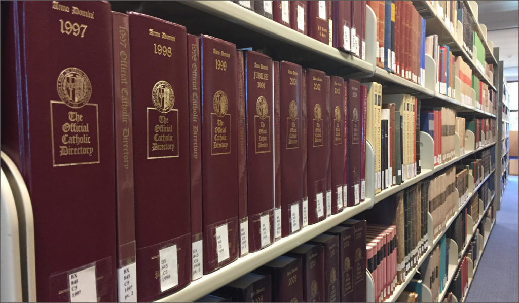 These Catholic directories, from the Gonzaga University library, list the locations of Catholic priests over time, showing how Jesuits were shuffled around following abuse accusations. CREDIT: EMILY SCHWING/N3