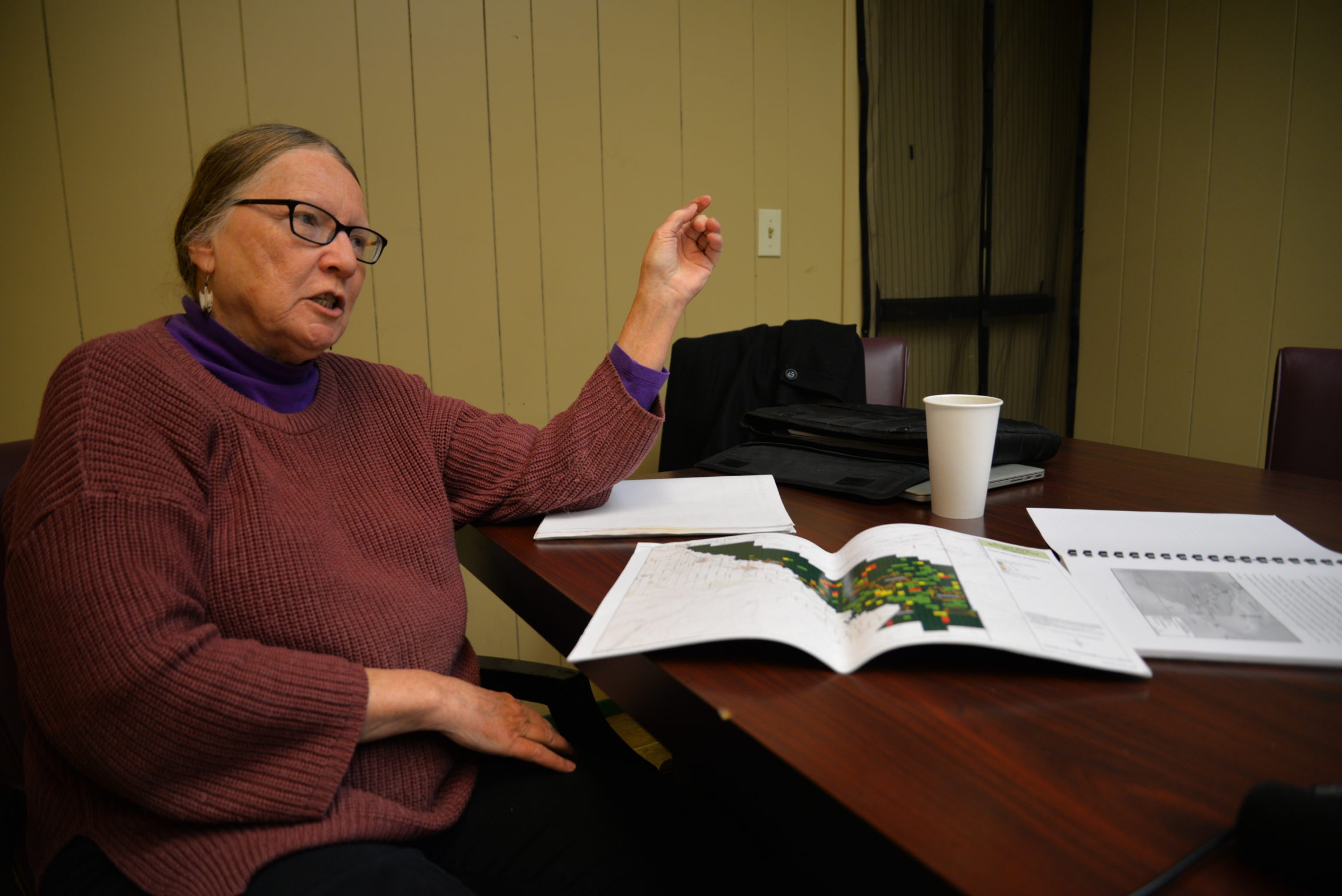 Environmental activist Jean Mendoza studies maps of monitoring wells in the Lower Yakima Valley. Mendoza has worked on a groundwater advisory committee for the last six years to develop a plan to reduce nitrates in drinking water. CREDIT: ESMY JIMENEZ/NWPB