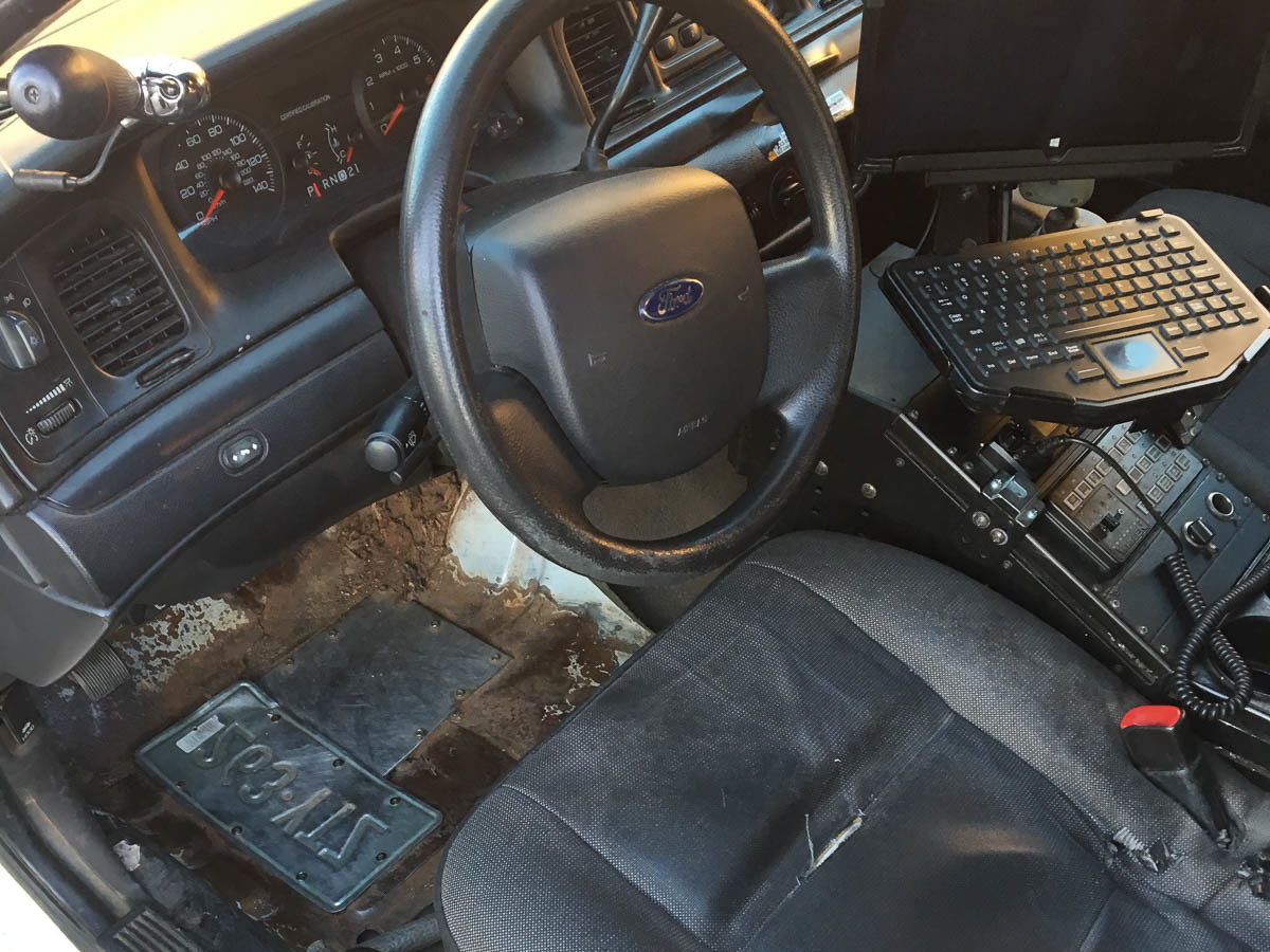 Holes in the floorboards of a New Haven Police Department squad car have been patched with an old license plate. CREDIT: CHRISTIAN BRUCKHART/NEW HAVEN POLICE DEPARTMENT