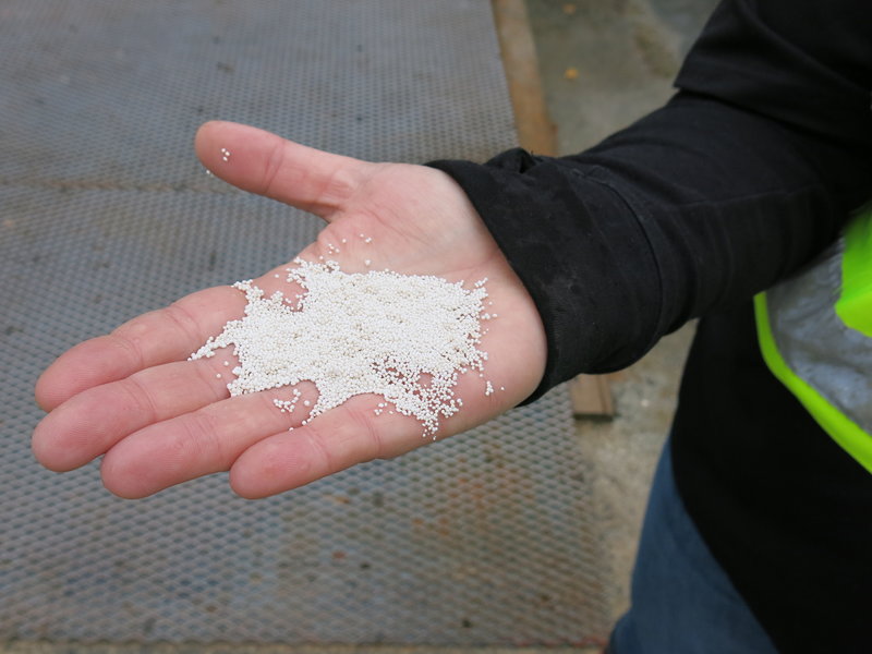 McCahill holds pellets containing carbon dioxide that the company captured from the air. CREDIT: JEFF BRADY/NPR